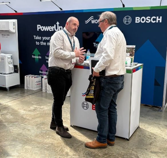 Two people talking at the stand